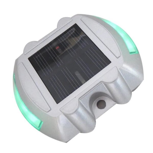Green LED road stud with solar energy, ideal for traffic safety.