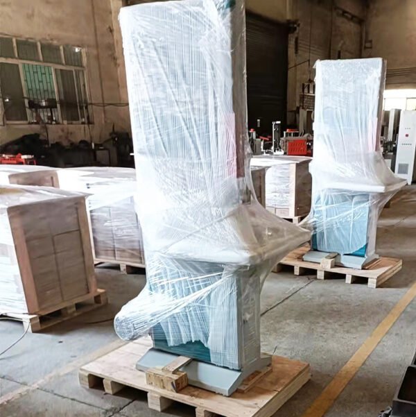 Two vertical band saws wrapped in protective film for safe transportation