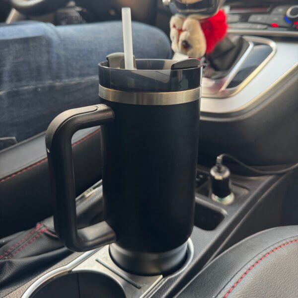 Black Handle Thermos Cup placed in a car cup holder