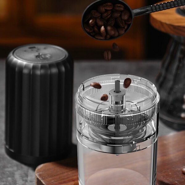 Portable coffee grinder with an open bean hopper, ready for coffee beans