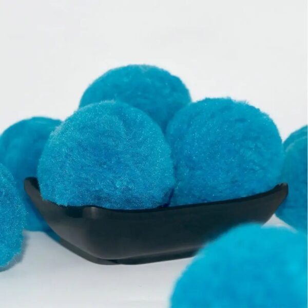 Blue polyester filter balls displayed on a black plate for visual appeal