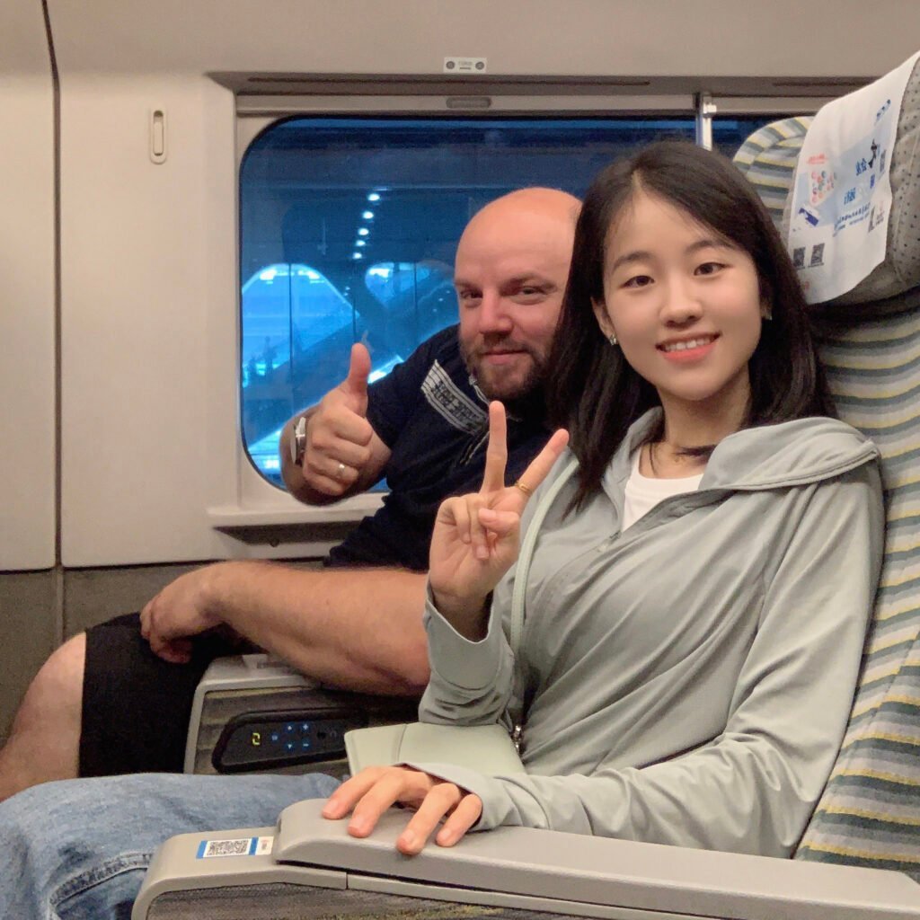 Tiny and Czech Client on a Journey of Success Tiny with her Czech client on a high-speed train, reflecting successful international business ventures.