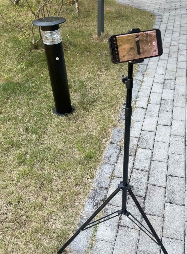 On-Site Performance Testing for Solar Lawn Lights Tripod recording a solar lawn light performance test on grass