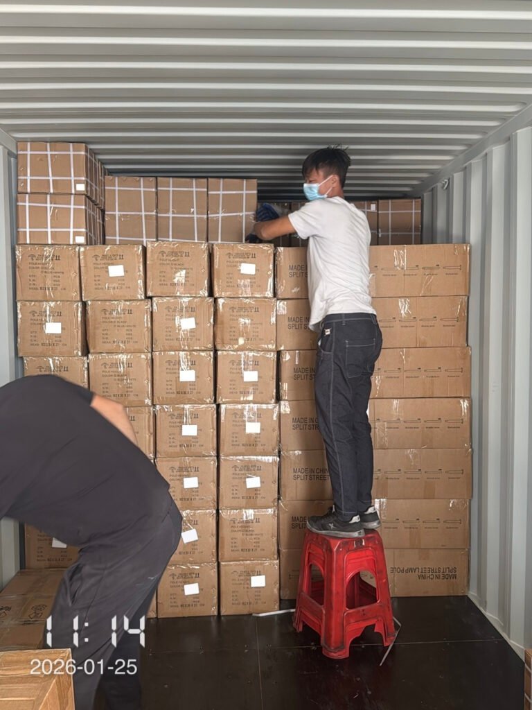 Workers using stools to stack cargo high