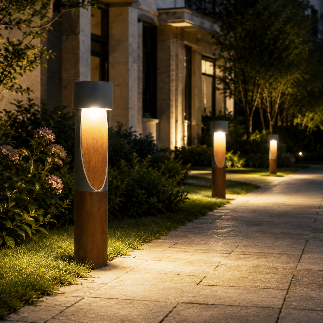 Shielded wood-effect LED bollard lights illuminating a landscaped garden pathway at night