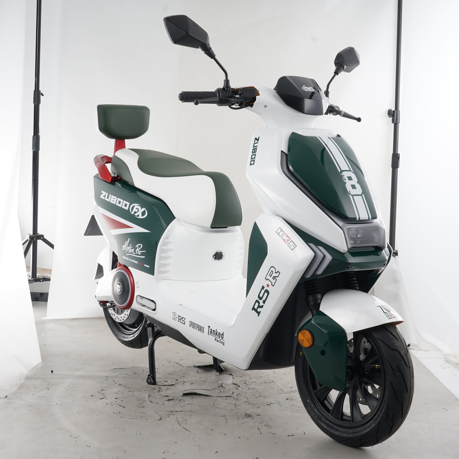 White and green step-through electric motorcycle shown from the opposite front angle with full body panels and passenger backrest