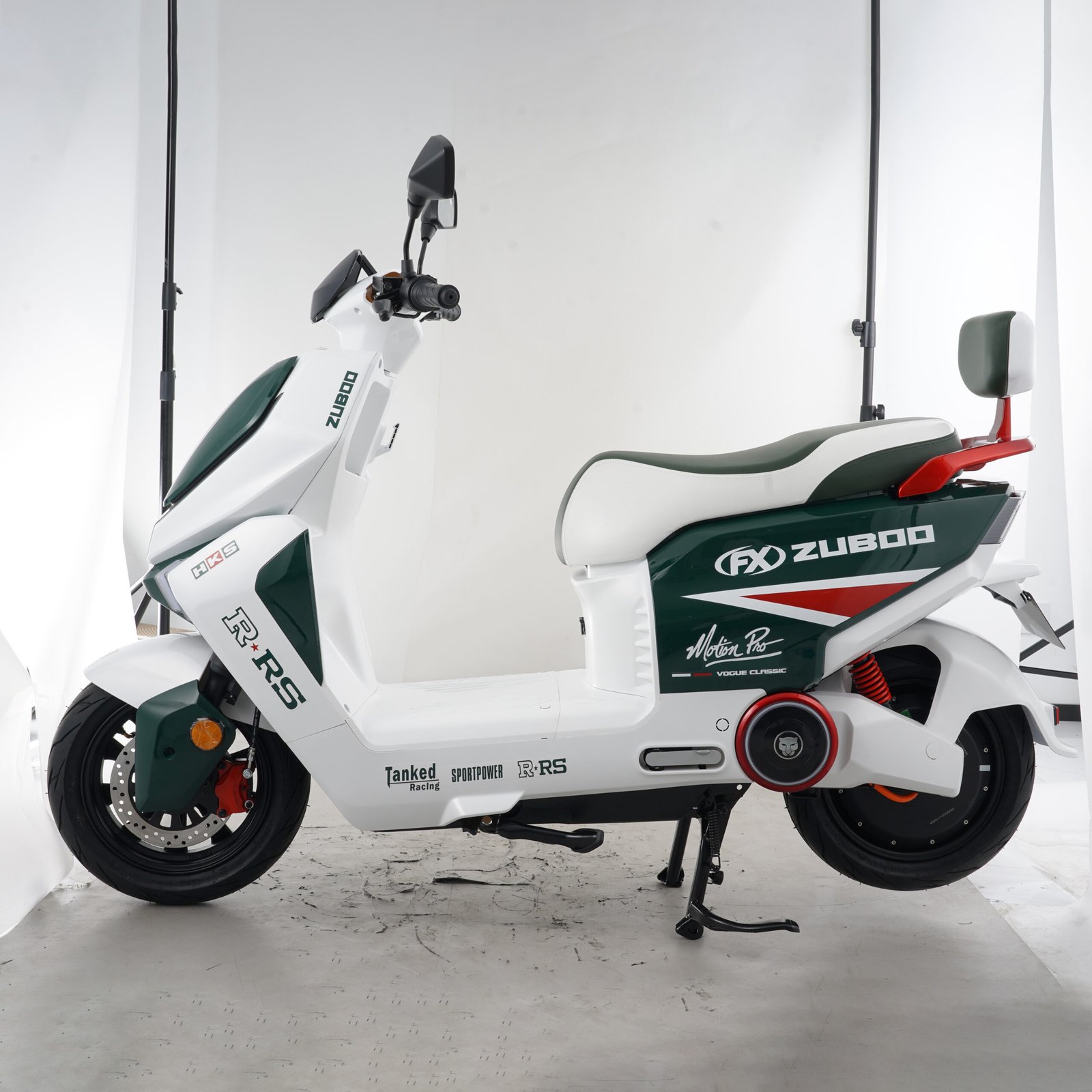Side profile of a white and green step-through electric motorcycle showing the long seat, footboard and rear passenger backrest