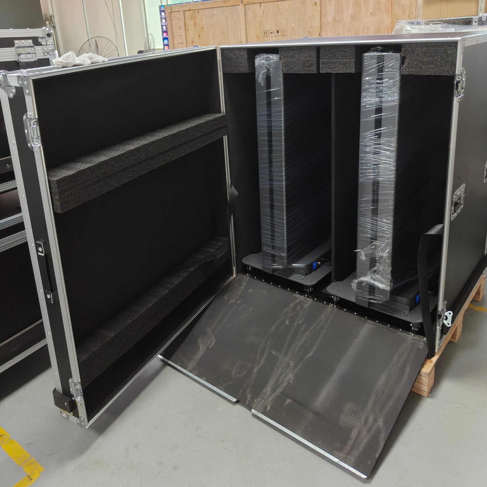Foldable LED poster screen in a partially folded position showing the cabinet hinge and frame