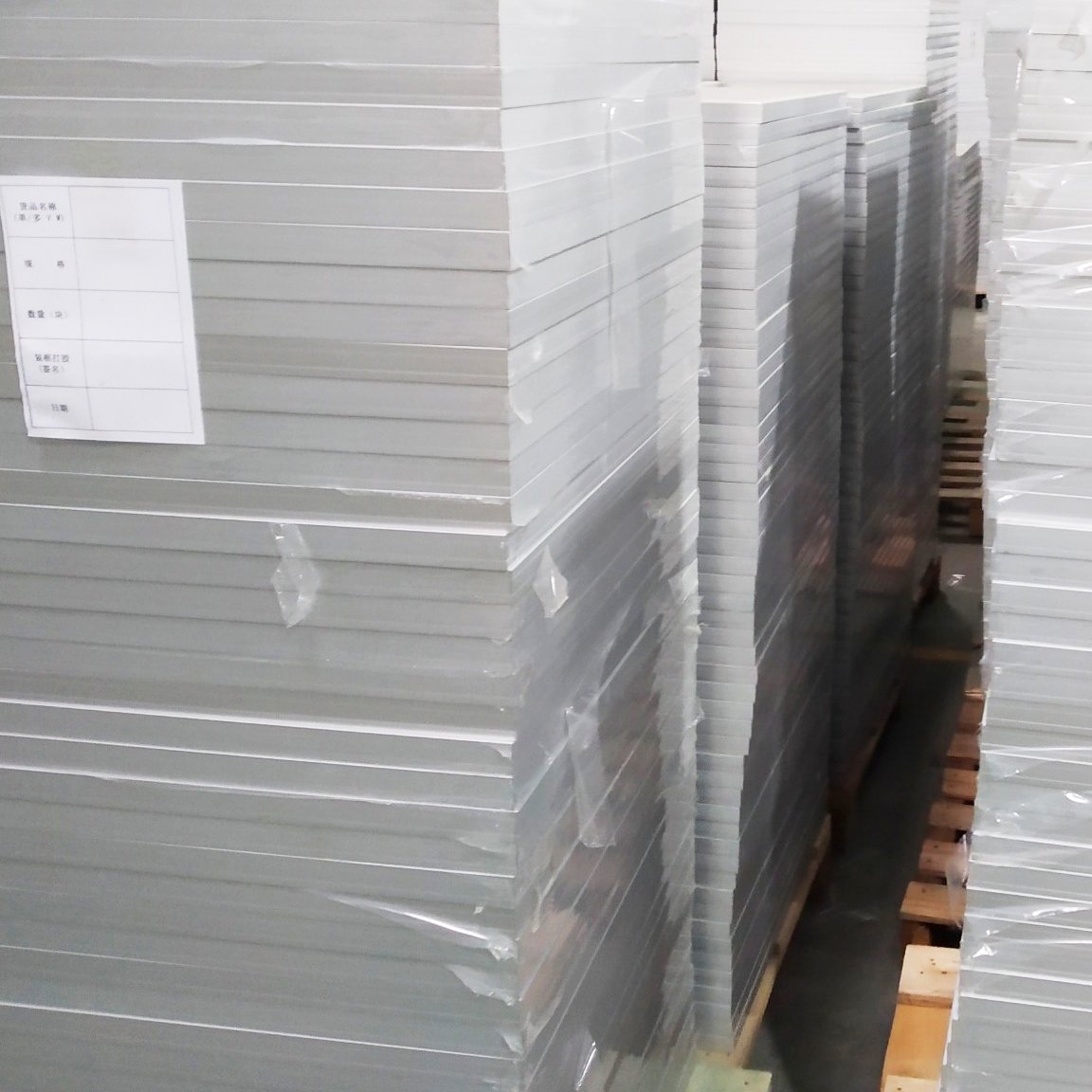 Stacks of small framed solar panels prepared during bulk production and handling